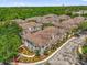 Aerial view of the well-maintained townhome community surrounded by mature trees and lush landscaping at 2950 Lucayan Harbour Cir # 107, Kissimmee, FL 34746