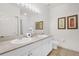 Bright bathroom features double sinks, a large mirror with vanity lights, and neutral tile at 2950 Lucayan Harbour Cir # 107, Kissimmee, FL 34746