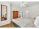 Bright bedroom features a decorative bedspread, ceiling fan, and wood flooring at 2950 Lucayan Harbour Cir # 107, Kissimmee, FL 34746
