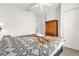 Bright bedroom features a patterned bedspread, ceiling fan, and white closet doors at 2950 Lucayan Harbour Cir # 107, Kissimmee, FL 34746