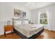 Bedroom with a queen bed, wood floors, and a window at 2950 Lucayan Harbour Cir # 107, Kissimmee, FL 34746