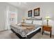Bright bedroom features a decorative bed frame, side tables, and beach-themed art at 2950 Lucayan Harbour Cir # 107, Kissimmee, FL 34746