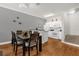 Dining room adjacent to a bright white kitchen with wood floors at 2950 Lucayan Harbour Cir # 107, Kissimmee, FL 34746