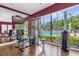 Bright gym with exercise equipment and large windows overlooking the pool area at 2950 Lucayan Harbour Cir # 107, Kissimmee, FL 34746