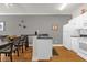 Kitchen with a bar area, a dining table, and white appliances at 2950 Lucayan Harbour Cir # 107, Kissimmee, FL 34746