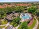 Aerial view of the community pool, clubhouse, palm trees and lounge chairs, perfect for relaxation at 2950 Lucayan Harbour Cir # 107, Kissimmee, FL 34746