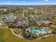 Aerial view of the clubhouse, pool, tennis courts, and well-maintained community amenities at 7274 Sw 95Th Ave, Ocala, FL 34481