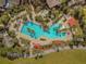 Aerial view of community pool with lush landscaping and ample seating at 7274 Sw 95Th Ave, Ocala, FL 34481