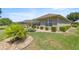 Spacious backyard with manicured landscaping, including shrubs and stone accents at 7274 Sw 95Th Ave, Ocala, FL 34481