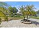 This backyard features a brick patio, luscious landscaping, mature trees, and an iron fence surrounding the yard at 7274 Sw 95Th Ave, Ocala, FL 34481