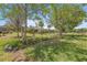 Lush backyard featuring green grass, trees, and flower beds, creating a serene outdoor retreat at 7274 Sw 95Th Ave, Ocala, FL 34481