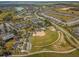 Aerial view of a well-kept baseball field near tennis courts and community facilities within a picturesque neighborhood setting at 7274 Sw 95Th Ave, Ocala, FL 34481