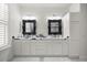 Bright bathroom featuring dual sinks with elegant mirrors and ample counter space at 7274 Sw 95Th Ave, Ocala, FL 34481