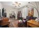 This room features a mirrored closet, area rug, ceiling fan, window with shutters, and lots of natural lighting at 7274 Sw 95Th Ave, Ocala, FL 34481