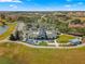 Aerial view of a modern clubhouse with inviting outdoor seating, set in a beautifully landscaped community at 7274 Sw 95Th Ave, Ocala, FL 34481