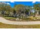 Stone Creek entrance with rock waterfall feature surrounded by manicured landscaping and a welcoming sidewalk at 7274 Sw 95Th Ave, Ocala, FL 34481
