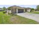 Exterior view displays a driveway, well maintained lawn and beautiful landscaping at 7274 Sw 95Th Ave, Ocala, FL 34481