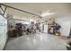 Spacious two-car garage with epoxy floors, overhead storage, and built-in shelving for optimal organization at 7274 Sw 95Th Ave, Ocala, FL 34481