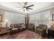 Cozy living room with hardwood floors, plantation shutters, and a decorative rug at 7274 Sw 95Th Ave, Ocala, FL 34481