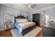 Spacious primary bedroom boasts hardwood floors, a chandelier and a decorative rug at 7274 Sw 95Th Ave, Ocala, FL 34481