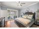 Inviting primary bedroom with an elegant chandelier and natural light from sliding glass doors at 7274 Sw 95Th Ave, Ocala, FL 34481