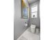 Stylish half bathroom featuring a modern toilet and decorative artwork at 7274 Sw 95Th Ave, Ocala, FL 34481