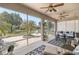 Relaxing sun room with lots of natural lighting, ceiling fans, a hanging swing, and access to the backyard at 7274 Sw 95Th Ave, Ocala, FL 34481