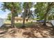 Backyard with mature trees, a white fence, and a boat parked in the rear at 2648 Ne 24Th Pl, Ocala, FL 34470