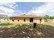 Backyard featuring a well-maintained lawn, patio, and exterior of the single story home at 2648 Ne 24Th Pl, Ocala, FL 34470