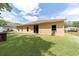 Backyard featuring a well-maintained lawn, patio, and exterior of the single story home at 2648 Ne 24Th Pl, Ocala, FL 34470