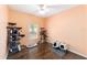 Spacious bedroom with dark wood flooring, ceiling fan, and multiple cat trees at 2648 Ne 24Th Pl, Ocala, FL 34470