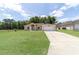 Charming single-story home with a well-manicured lawn and a spacious driveway leading to an attached garage at 2648 Ne 24Th Pl, Ocala, FL 34470