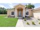 Welcoming front entrance with decorative columns and manicured landscaping at 2648 Ne 24Th Pl, Ocala, FL 34470