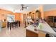 Bright kitchen with wooden cabinets, tile floors, and an adjacent dining area, perfect for Gathering meals at 2648 Ne 24Th Pl, Ocala, FL 34470