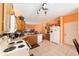 Well-lit kitchen featuring white appliances, wooden cabinets, tile flooring, and seamless access to other rooms at 2648 Ne 24Th Pl, Ocala, FL 34470