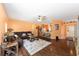 Open-concept living room with hardwood floors, neutral walls, and a modern ceiling fan at 2648 Ne 24Th Pl, Ocala, FL 34470