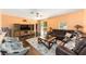 Spacious living room with hardwood floors, large windows, and comfortable seating at 2648 Ne 24Th Pl, Ocala, FL 34470