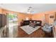 Bright living room with hardwood floors, sliding glass doors to the backyard, and contemporary furnishings at 2648 Ne 24Th Pl, Ocala, FL 34470