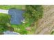 Aerial view of a house with a gray roof and a fenced backyard with mature trees at 23510 Oak Prairie Cir, Sorrento, FL 32776