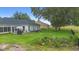 Expansive backyard features a dark metal fence, gazebo, outdoor seating, and mature trees at 23510 Oak Prairie Cir, Sorrento, FL 32776
