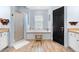 Bright bathroom featuring a soaking tub, walk-in shower, light blue walls and wood-look tile flooring at 23510 Oak Prairie Cir, Sorrento, FL 32776