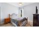 Light bedroom with a ceiling fan and a large window at 23510 Oak Prairie Cir, Sorrento, FL 32776