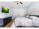 The bedroom includes a ceiling fan, a big window, and blue walls, creating a peaceful environment at 23510 Oak Prairie Cir, Sorrento, FL 32776