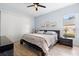 The bedroom includes a ceiling fan, a big window, and blue walls, creating a peaceful environment at 23510 Oak Prairie Cir, Sorrento, FL 32776