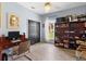 Bright bedroom with a desk, closet, ceiling fan, and bookshelf with a view of the backyard at 23510 Oak Prairie Cir, Sorrento, FL 32776
