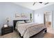 The bedroom includes a ceiling fan, a big window, and blue walls, creating a peaceful environment at 23510 Oak Prairie Cir, Sorrento, FL 32776