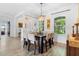 Bright dining room features a dark wood table, chandelier, wood-look flooring and neutral walls at 23510 Oak Prairie Cir, Sorrento, FL 32776