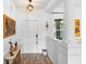 Bright white foyer featuring a front door, beautiful chandelier, wood floors, and entry to other rooms at 23510 Oak Prairie Cir, Sorrento, FL 32776