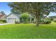 Lovely one-story house boasts a spacious front yard with mature trees and manicured landscaping at 23510 Oak Prairie Cir, Sorrento, FL 32776
