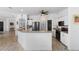 Eat-in kitchen with wood-look tile flooring, stainless steel appliances, and open to living areas at 23510 Oak Prairie Cir, Sorrento, FL 32776